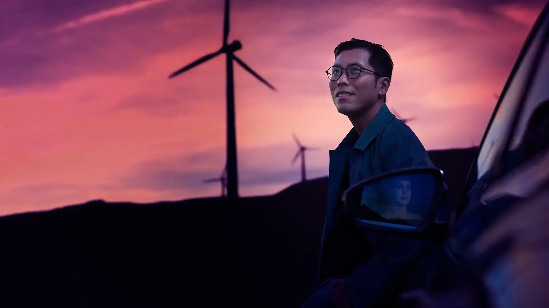 Eco conscious driver wind power sunset