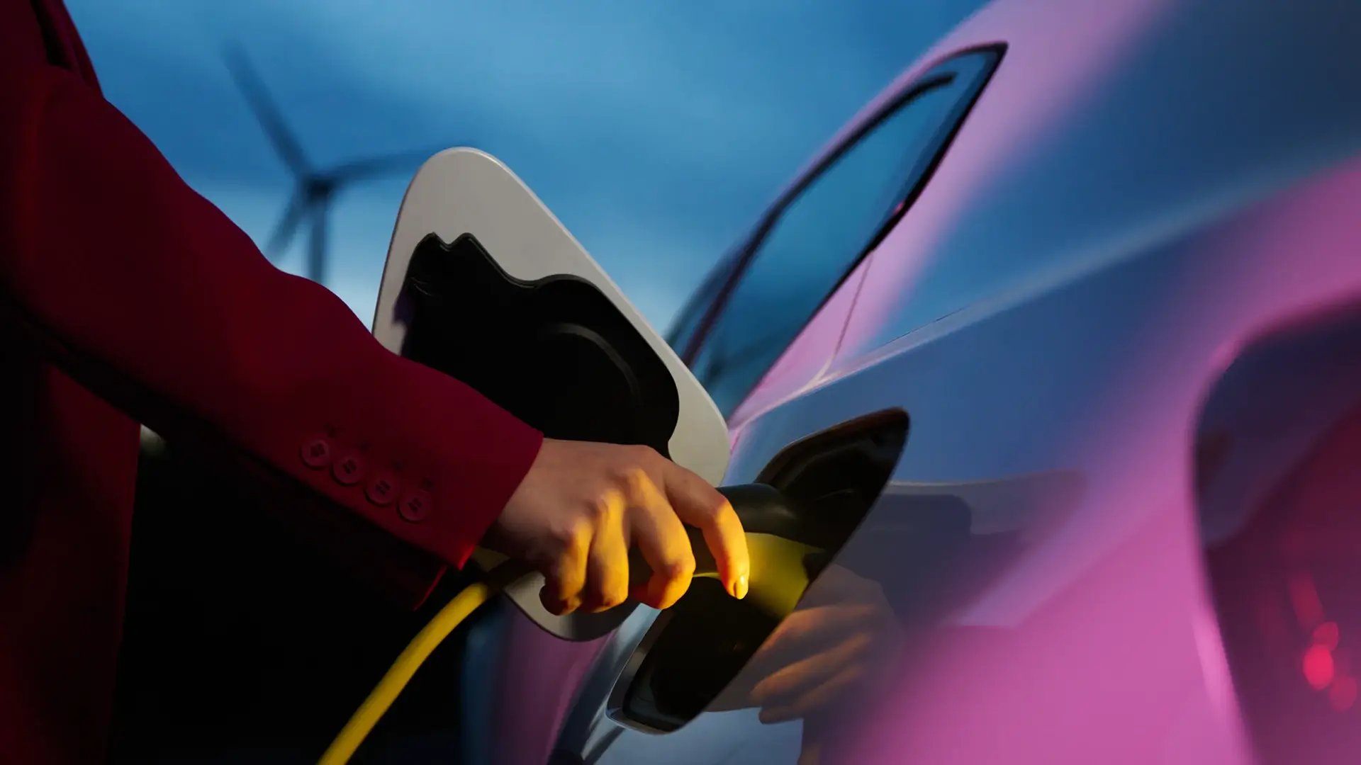 Woman charging EV wind turbine blue background