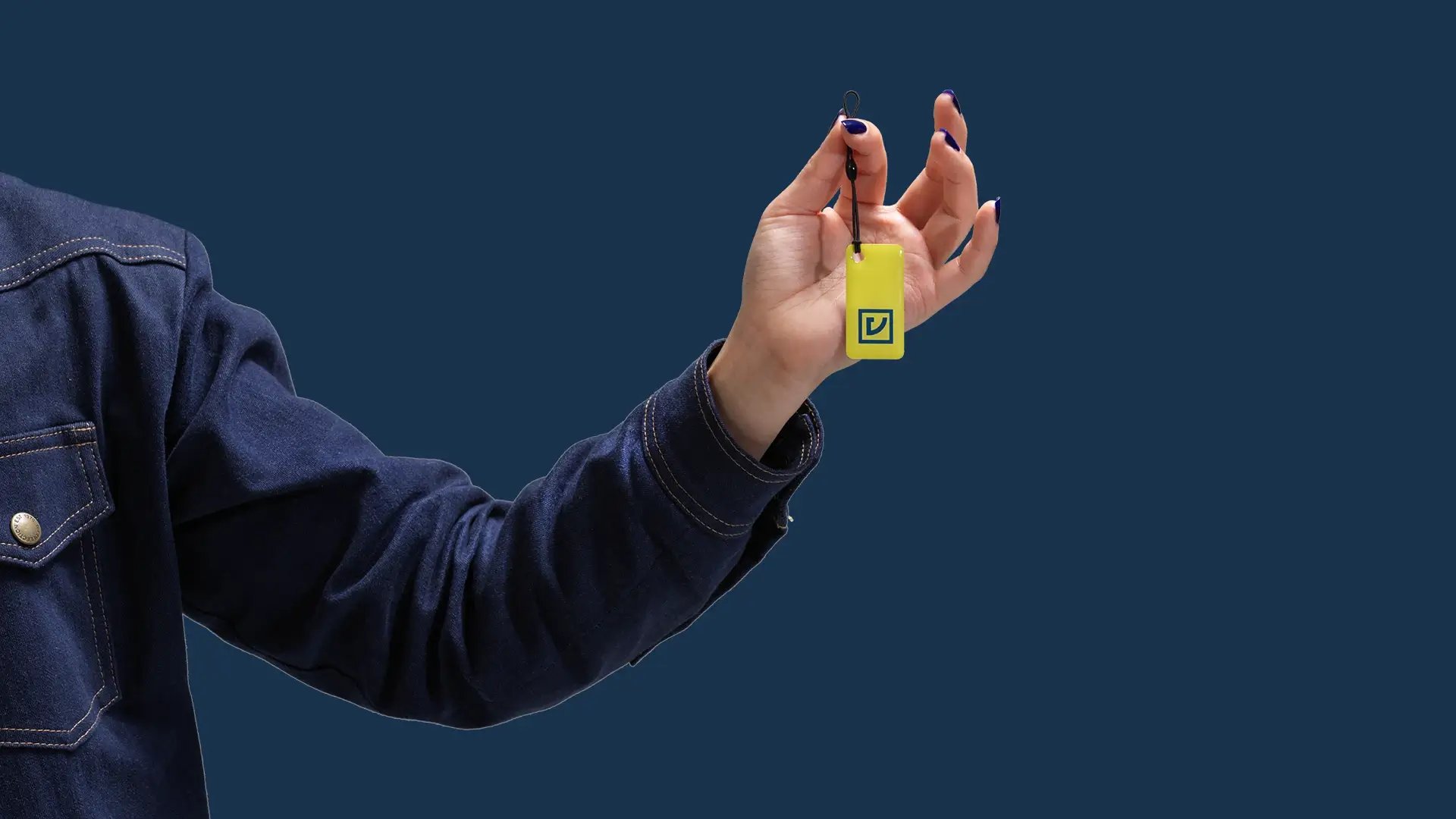 Hand holding RFID tag blue background