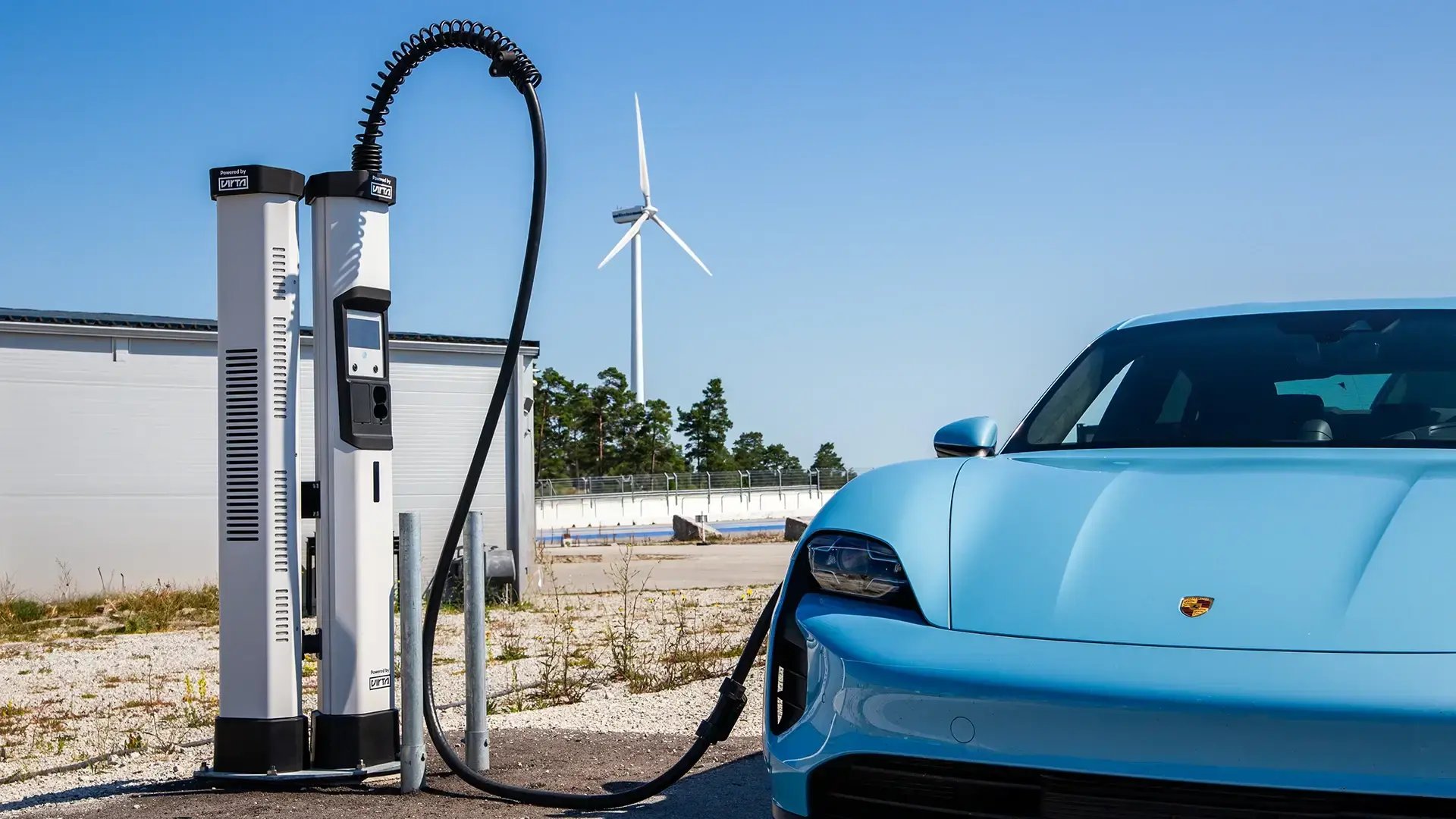 Blue EV HPC charging station wind turbines blue sky