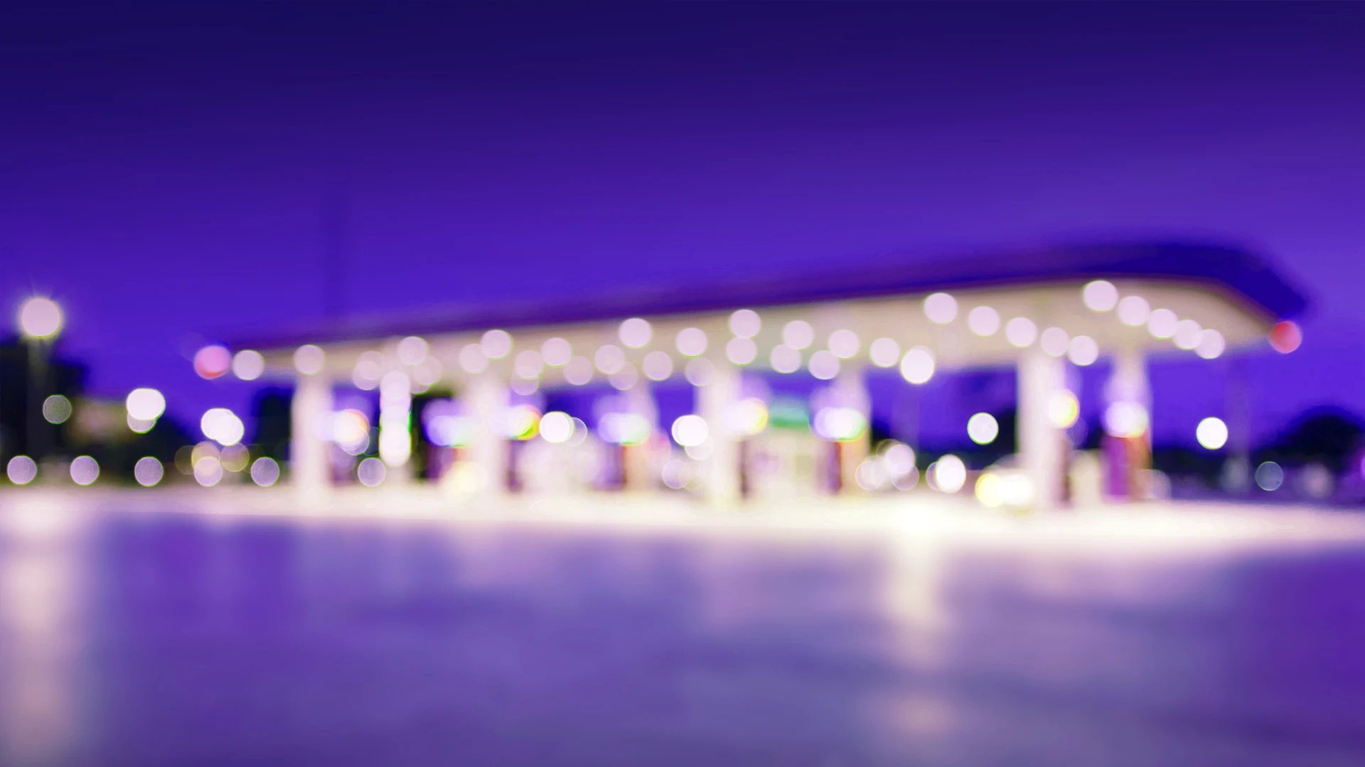 Blurred image of a petrol station in the early evening