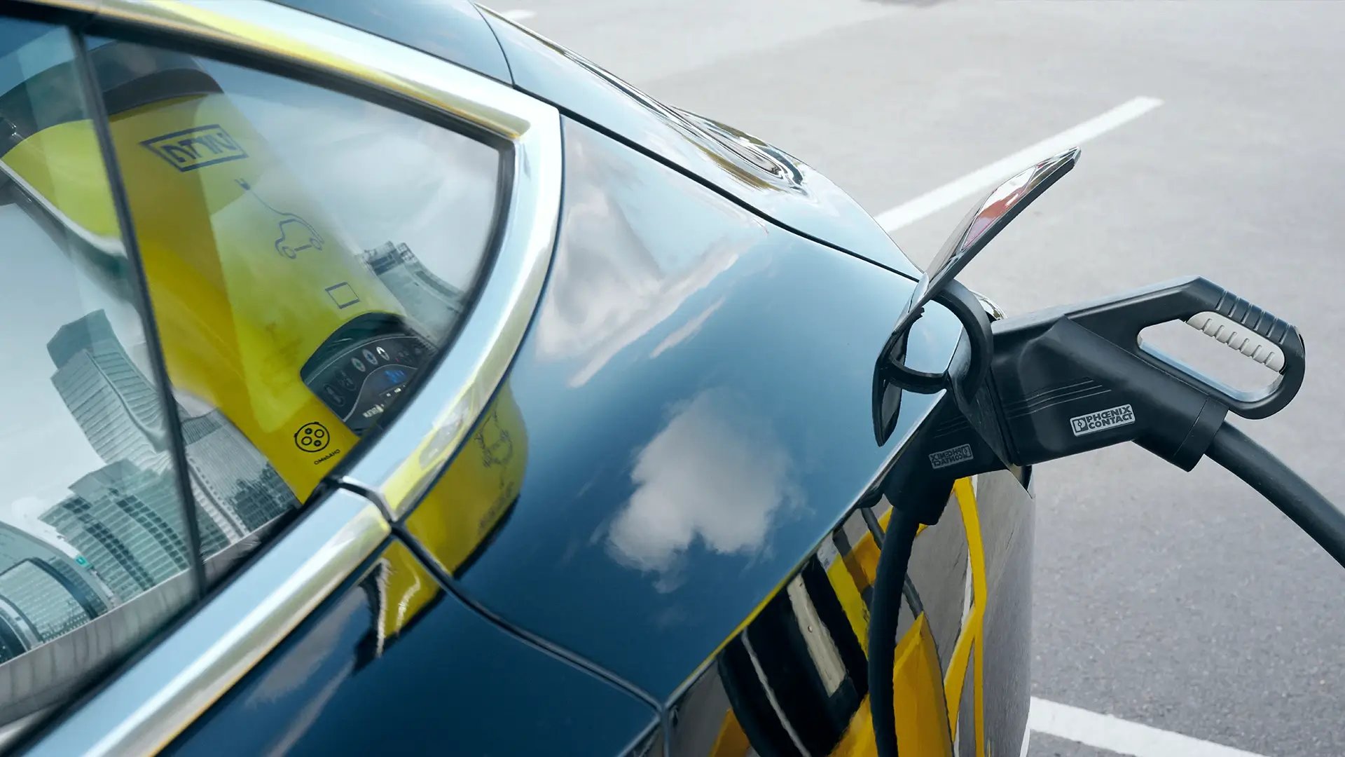Electric car with CCS charging connector cityscape reflection