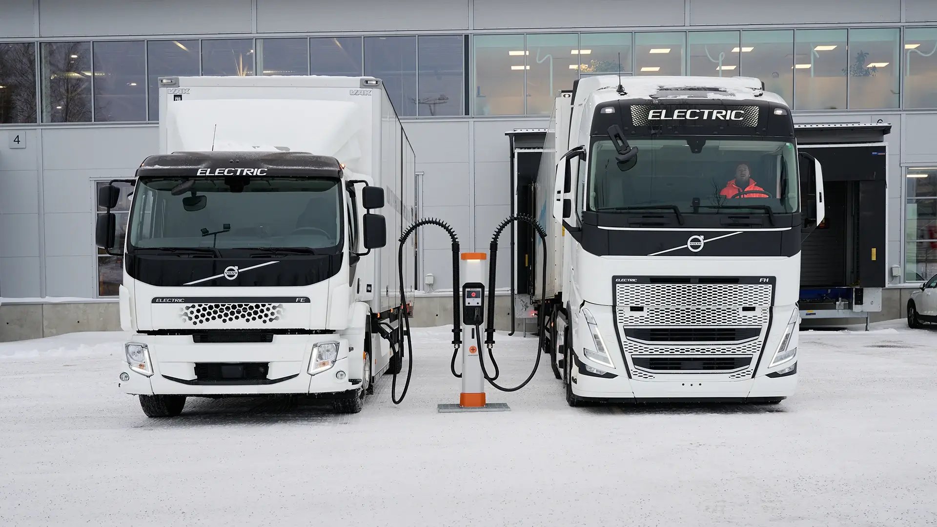 Electric trucks DC fast charging outside a logistics hub