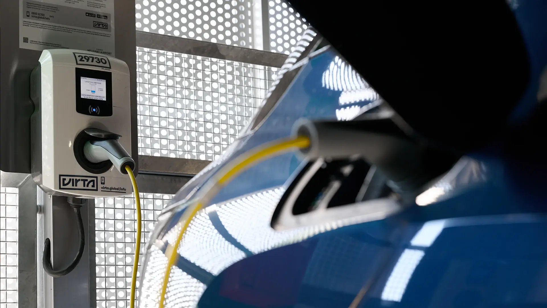Electric vehicle at urban parking garage connected to an AC charger