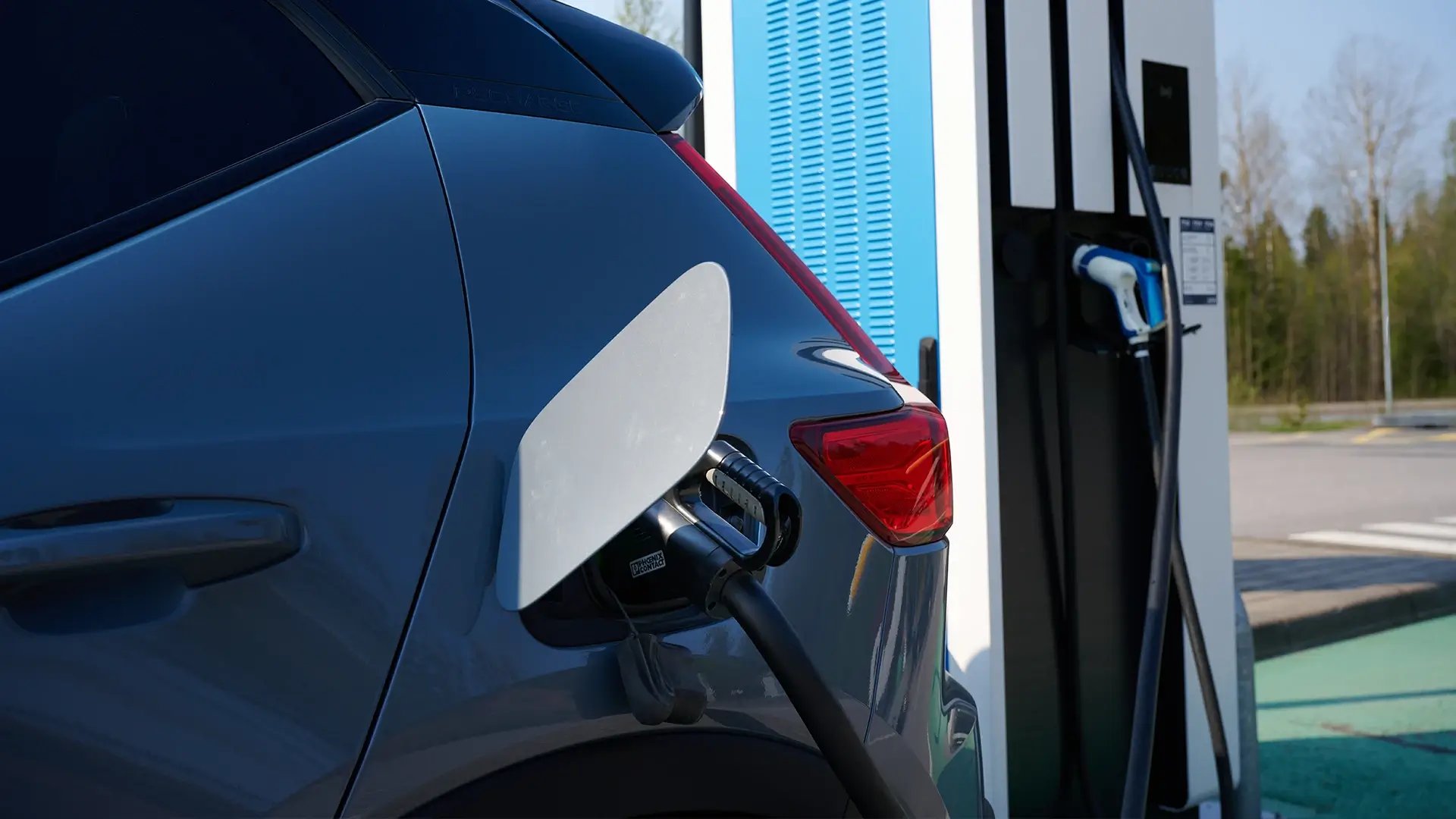 Blue EV charging public petrol station