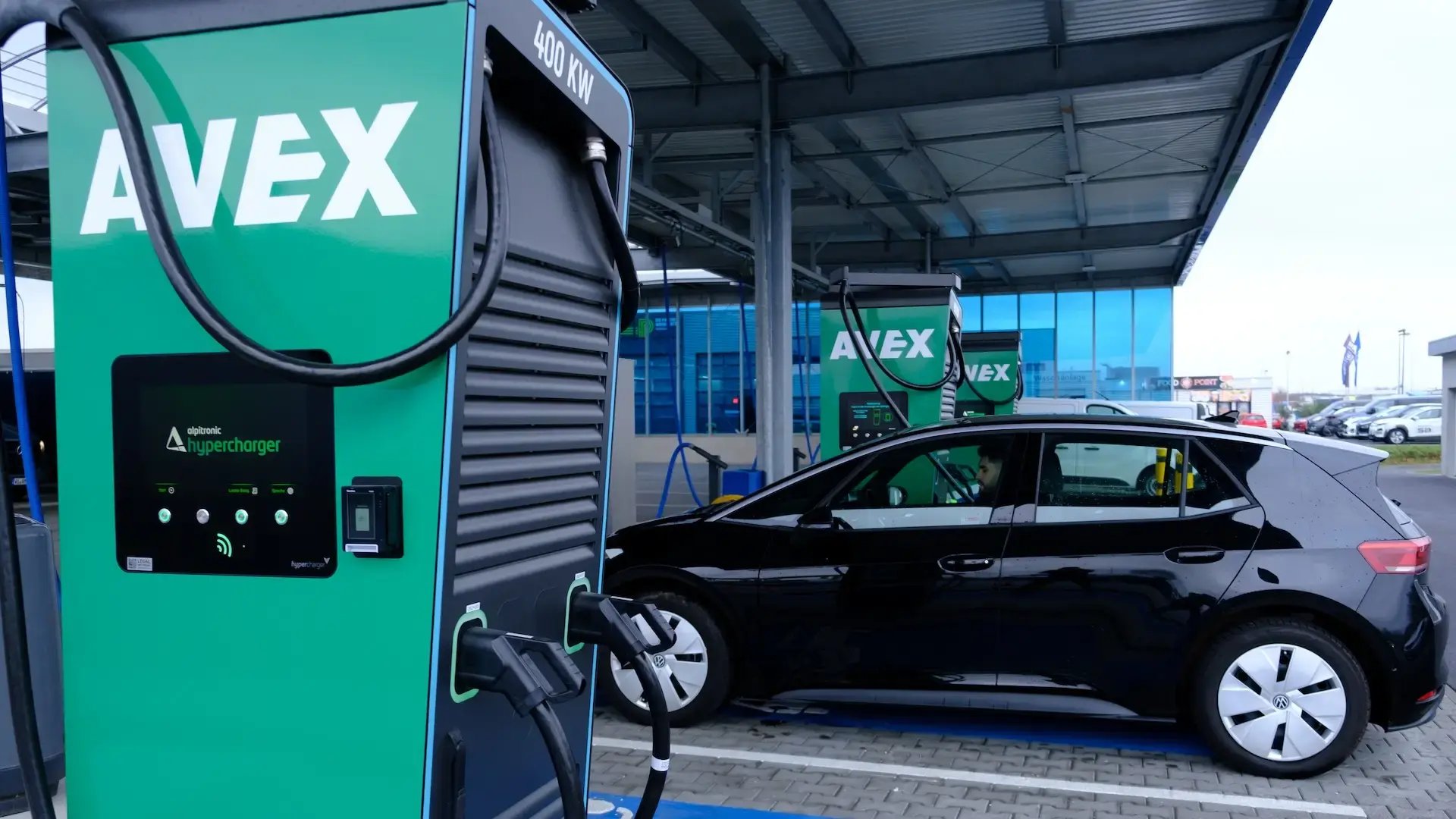 man-in-black-ev-charging-at-avex-ultra-fast-charging-hub