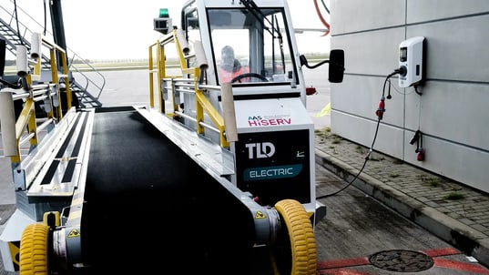 Electric vehicle luggage ramp charging airside with driver