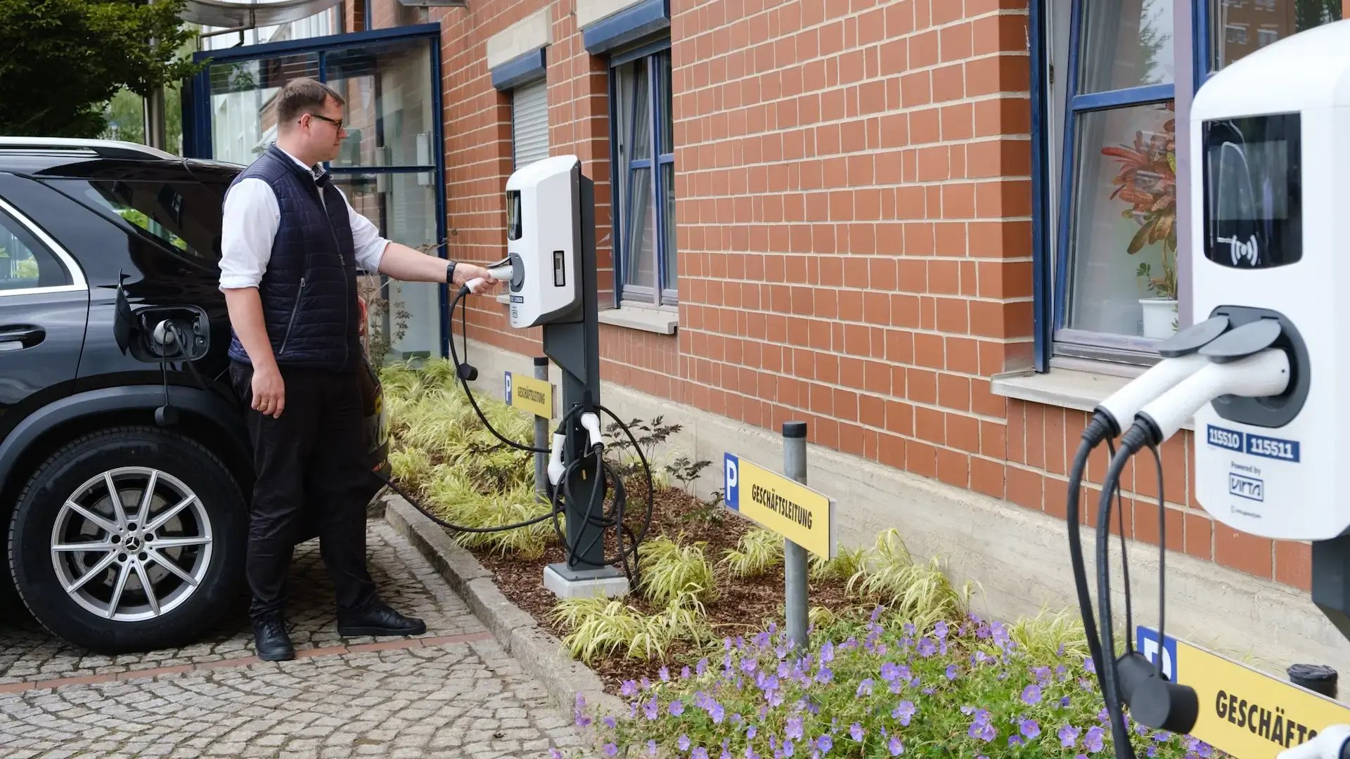 Felix Windrich, responsible for energy management at GP Günter Papenburg AG, charges an electric car at a charging station at the Hanover site