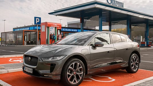 mt-komex-grey-car-charging-next-to-petrol-station