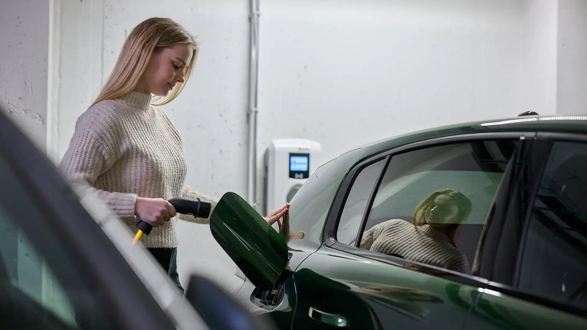 woman-charging-green-ev-at-ac-ev-charger