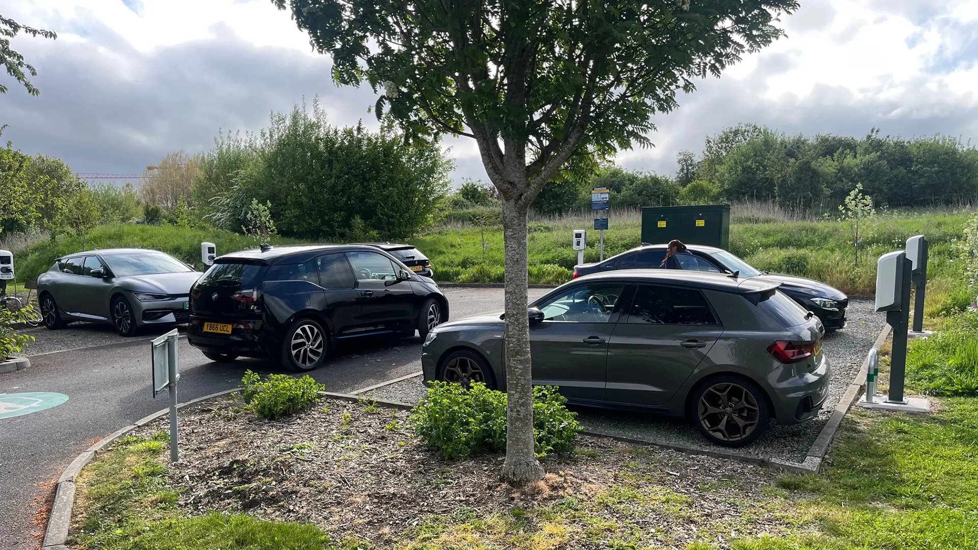 electric-vehicles-charging-at-a-site-next-to-greenery