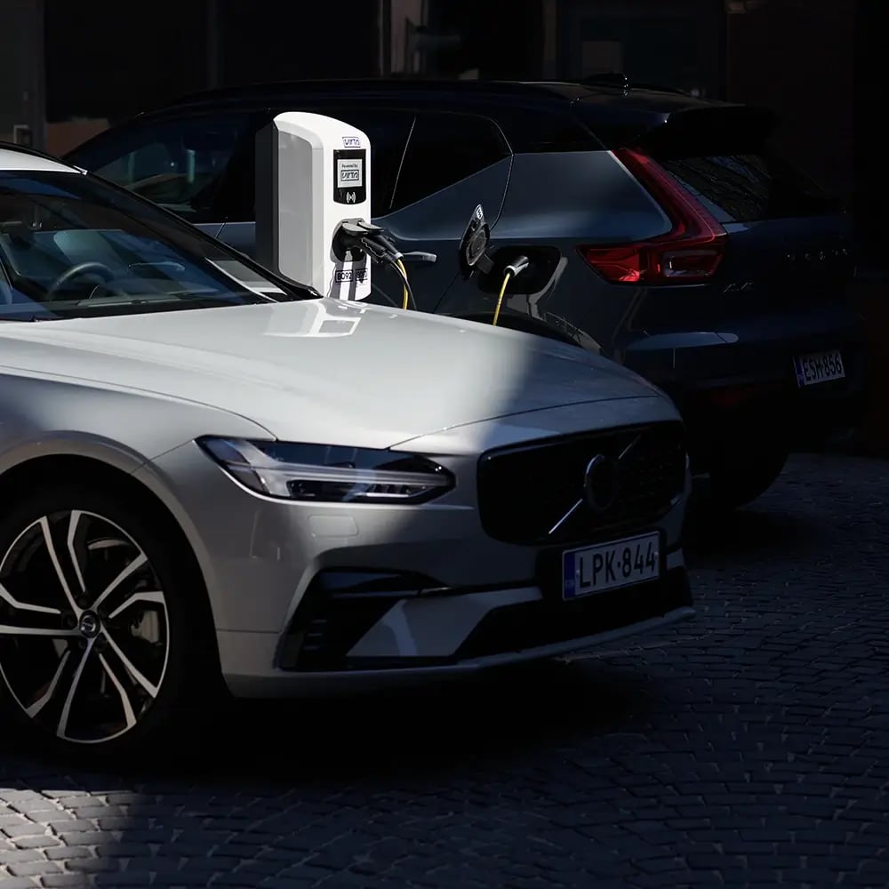 Multiple electric cars at charging station outside office