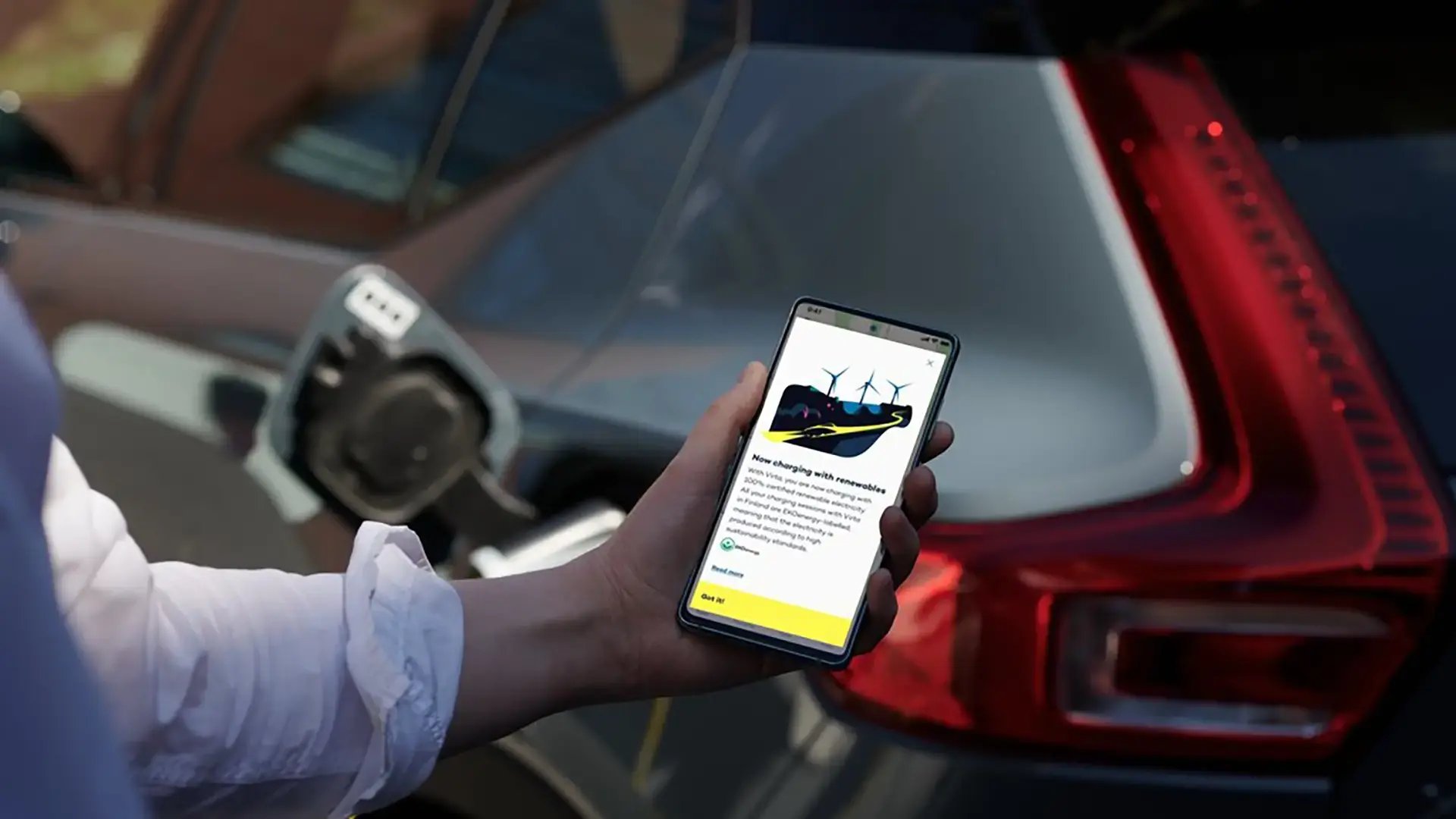 Hand holding phone with Virta Origin notification