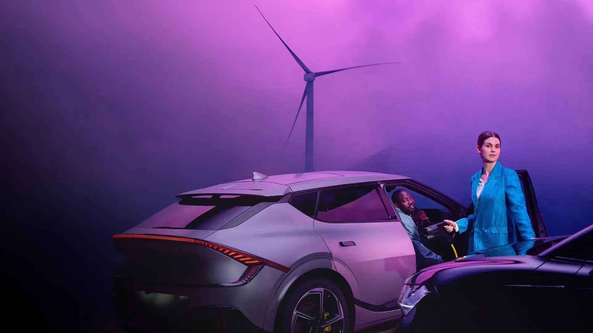 Woman and man charging EV wind turbine purple background