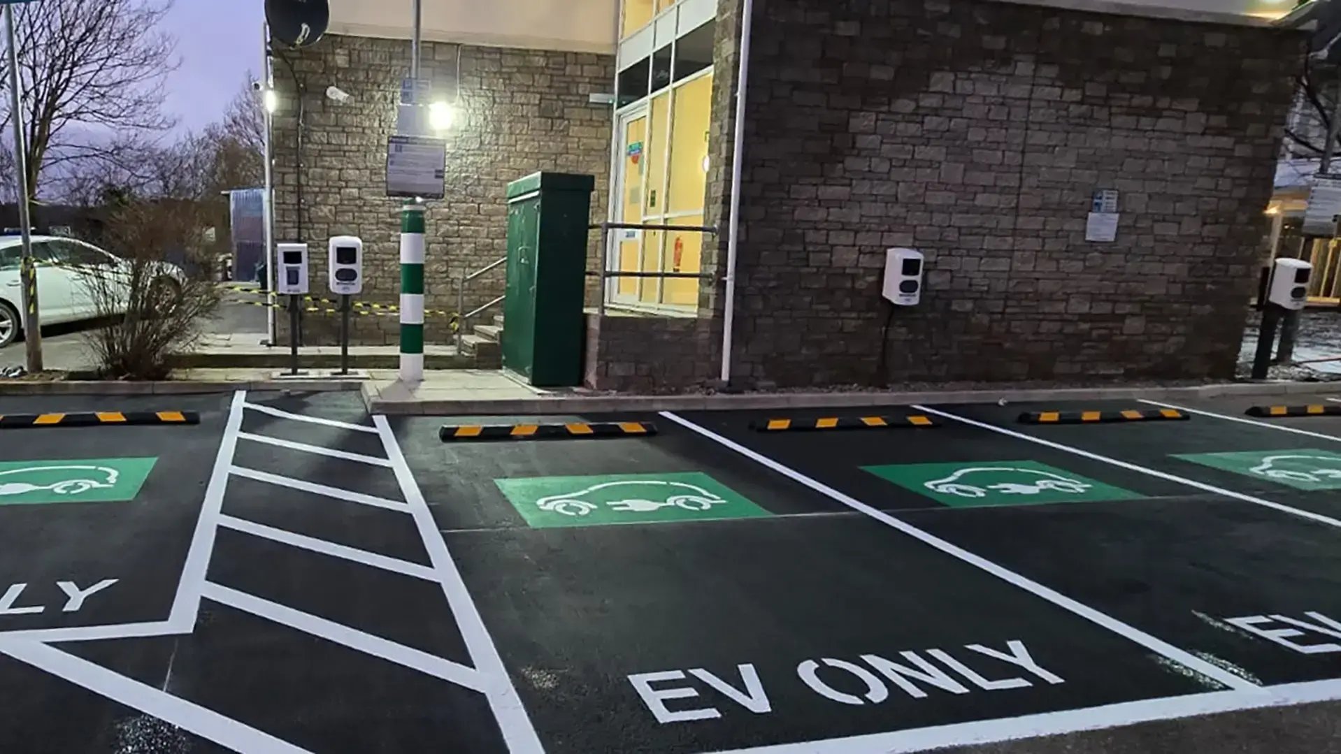 row-of-ac-chargers-payment-kiosk-parking-lot-2